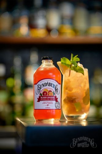 ORANG-A-TANG Mocktail with Bundaberg Blood Orange garnished with mint sprig and pineapple wedge